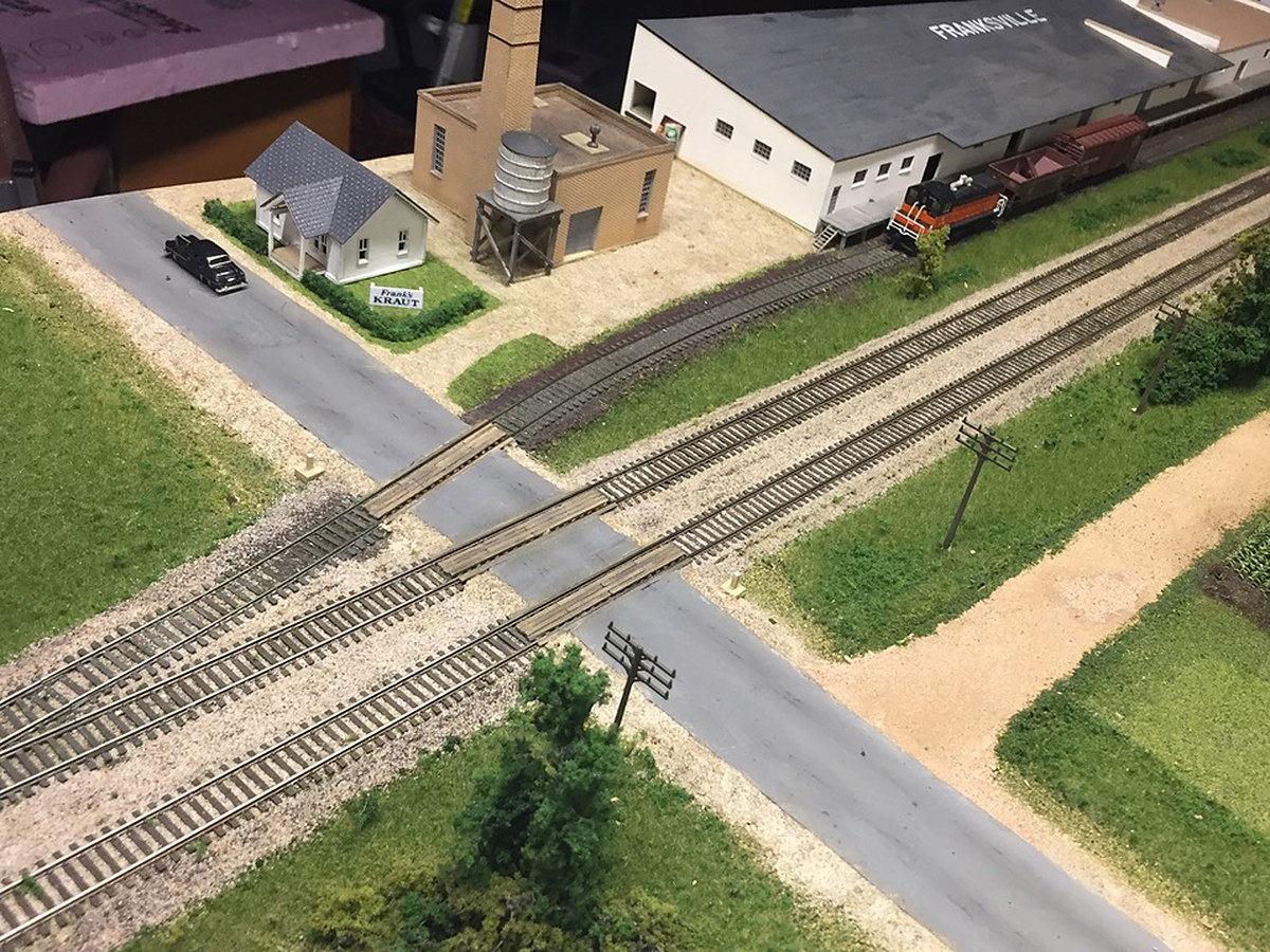 Kraut Road crossing the double main and the warehouse siding, with the FRANKSVILLE warehouse, brick building, water tank and white house