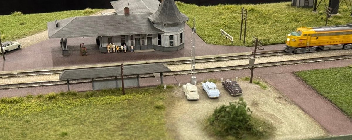 Sturtevant depot, platform shelter and gravel lot with a passenger train on the module